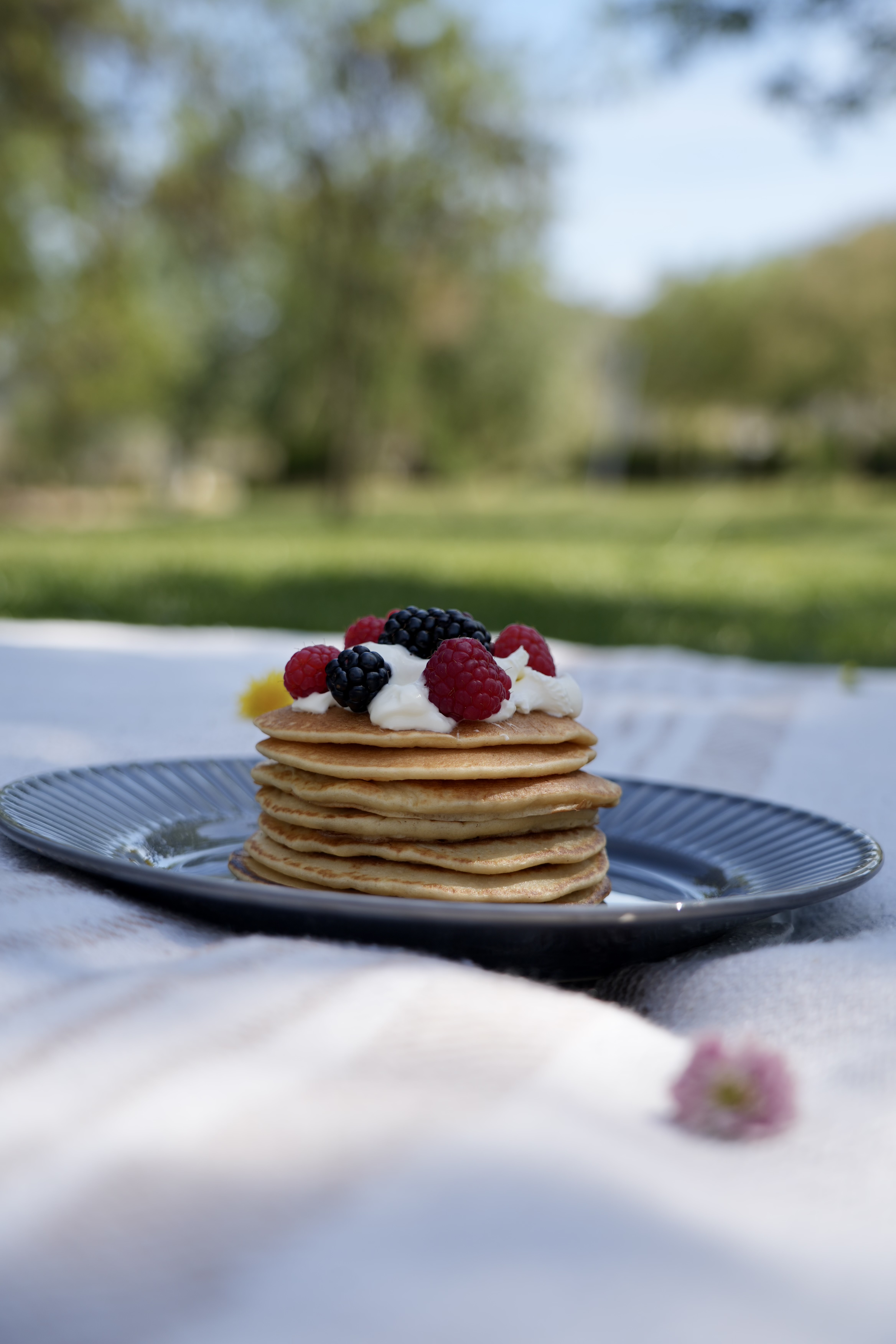 Stack of fluffy pancakes with cream and berries — family friendly catering by Michael Sepulveda